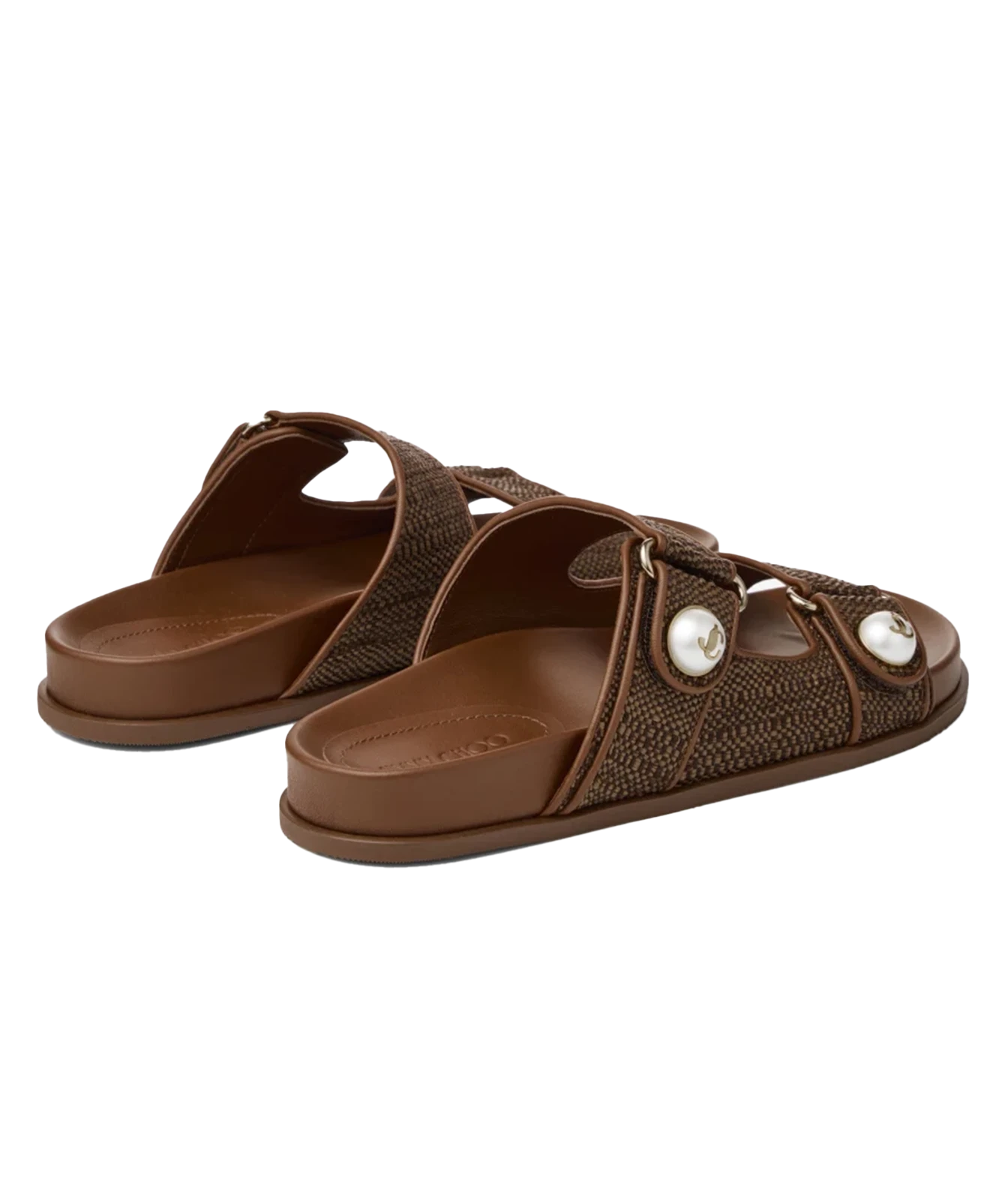 A pair of brown slide sandals with textured woven straps and decorative white pearl-like accents, shown on a plain white background.