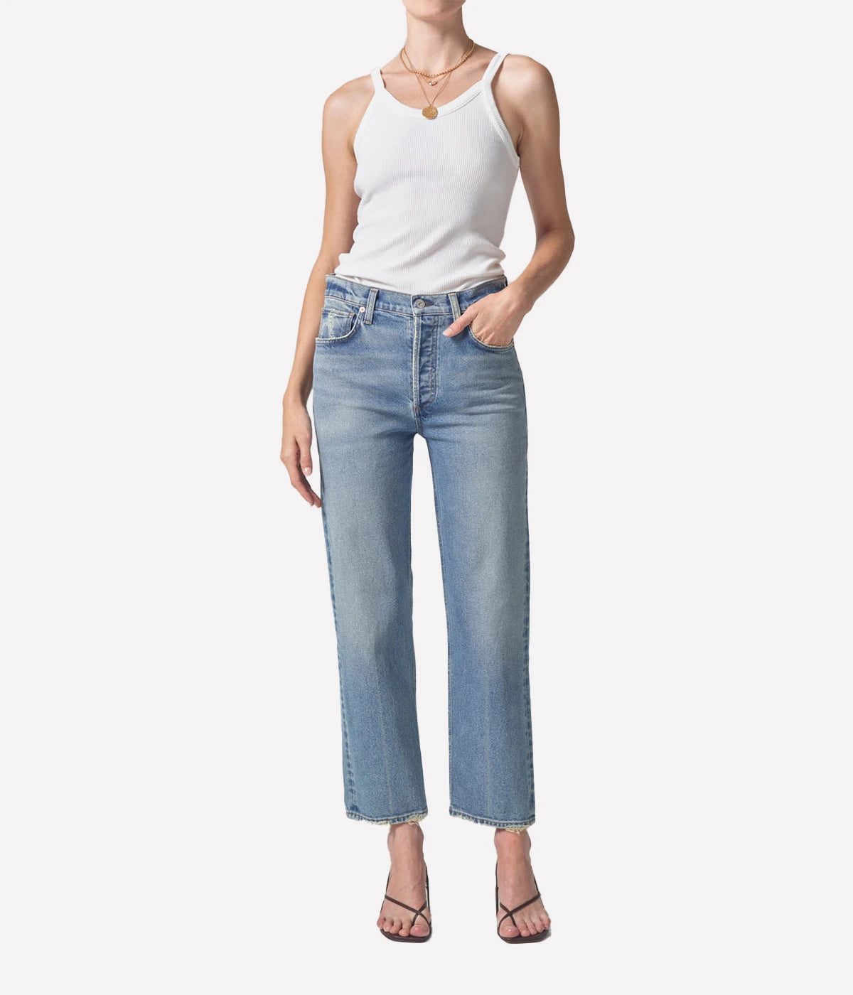 Relaxed straight-leg vintage-style jeans with a high-rise fit, styled with a cropped sweater and ankle boots for an elevated casual look.