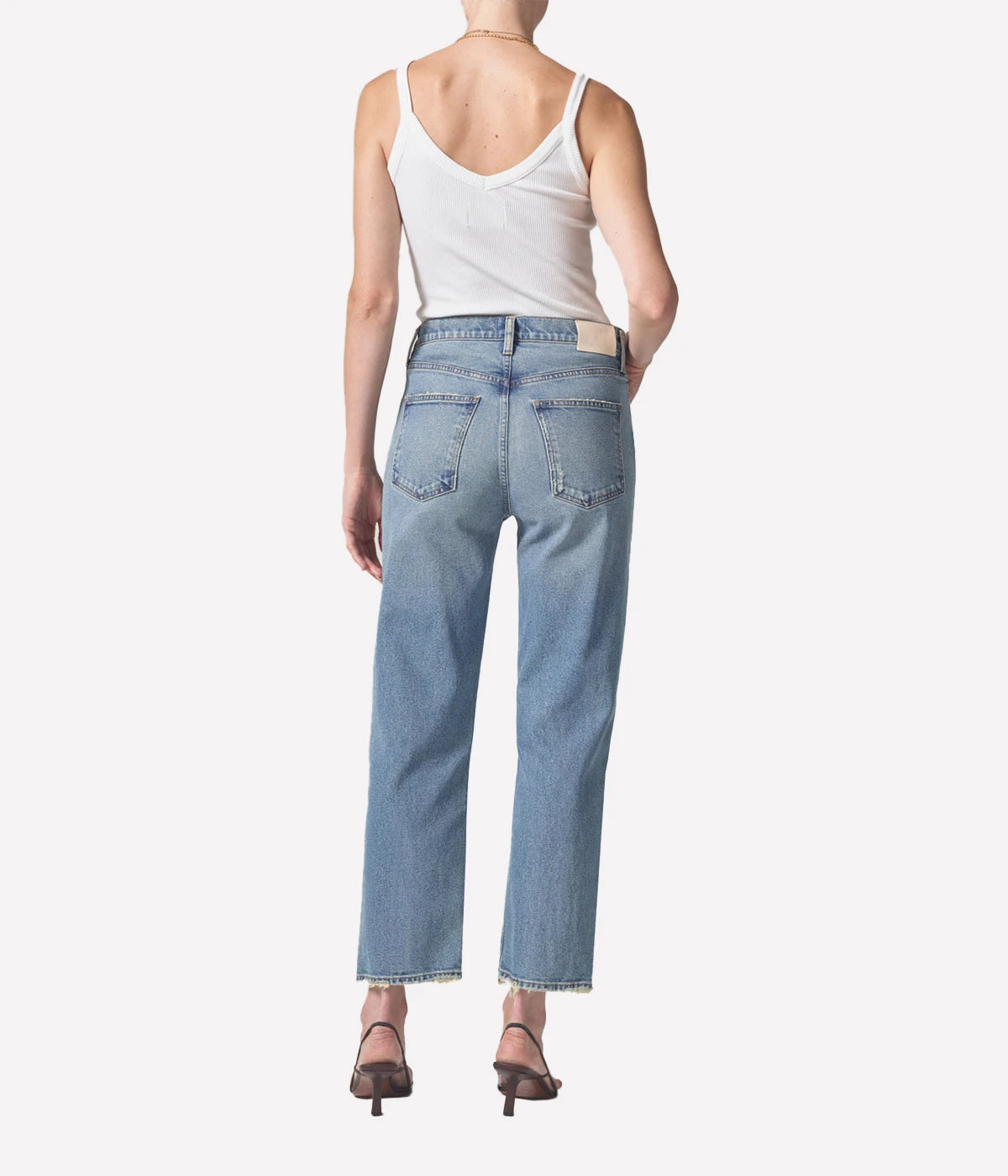 Relaxed straight-leg vintage-style jeans with a high-rise fit, styled with a cropped sweater and ankle boots for an elevated casual look.