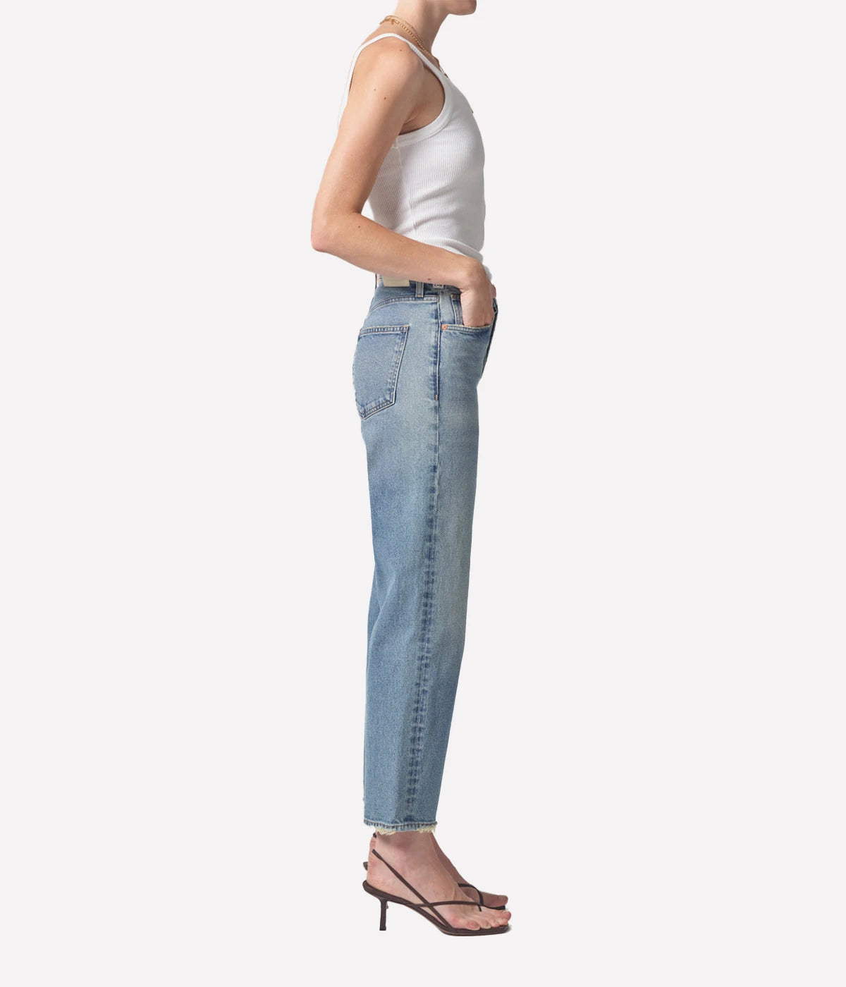 Relaxed straight-leg vintage-style jeans with a high-rise fit, styled with a cropped sweater and ankle boots for an elevated casual look.