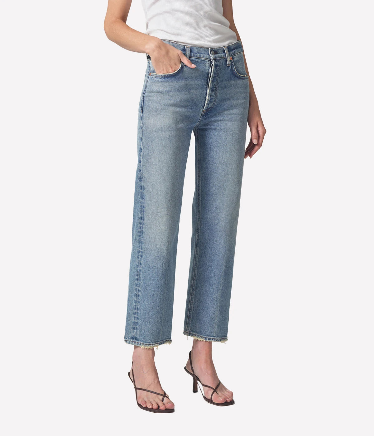 Relaxed straight-leg vintage-style jeans with a high-rise fit, styled with a cropped sweater and ankle boots for an elevated casual look.