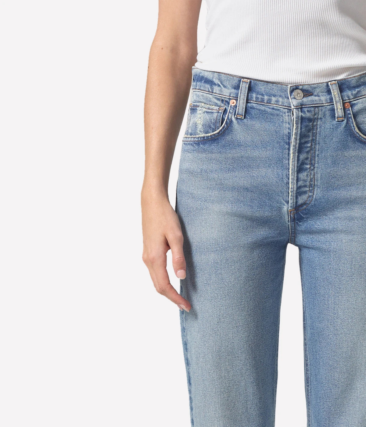 Relaxed straight-leg vintage-style jeans with a high-rise fit, styled with a cropped sweater and ankle boots for an elevated casual look.