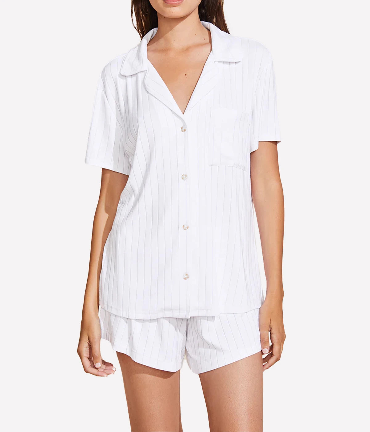 Relaxed pyjama set with a button-down top, notch collar, and mid-rise boyfriend fit shorts featuring tortoise-coloured buttons and contrast piping, styled for lounging or sleepwear.