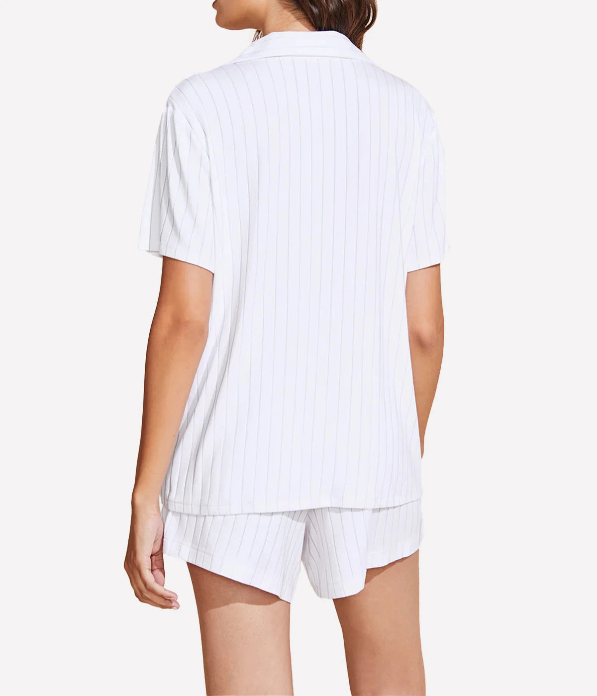 Relaxed pyjama set with a button-down top, notch collar, and mid-rise boyfriend fit shorts featuring tortoise-coloured buttons and contrast piping, styled for lounging or sleepwear.