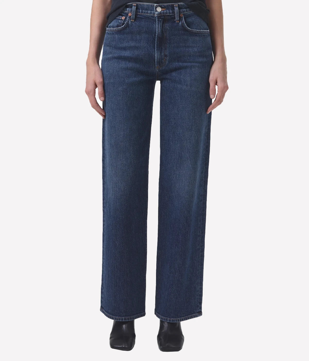 ALT Text: Dark-wash, high-waisted jeans with wide legs, ideal for retro-inspired outfits.