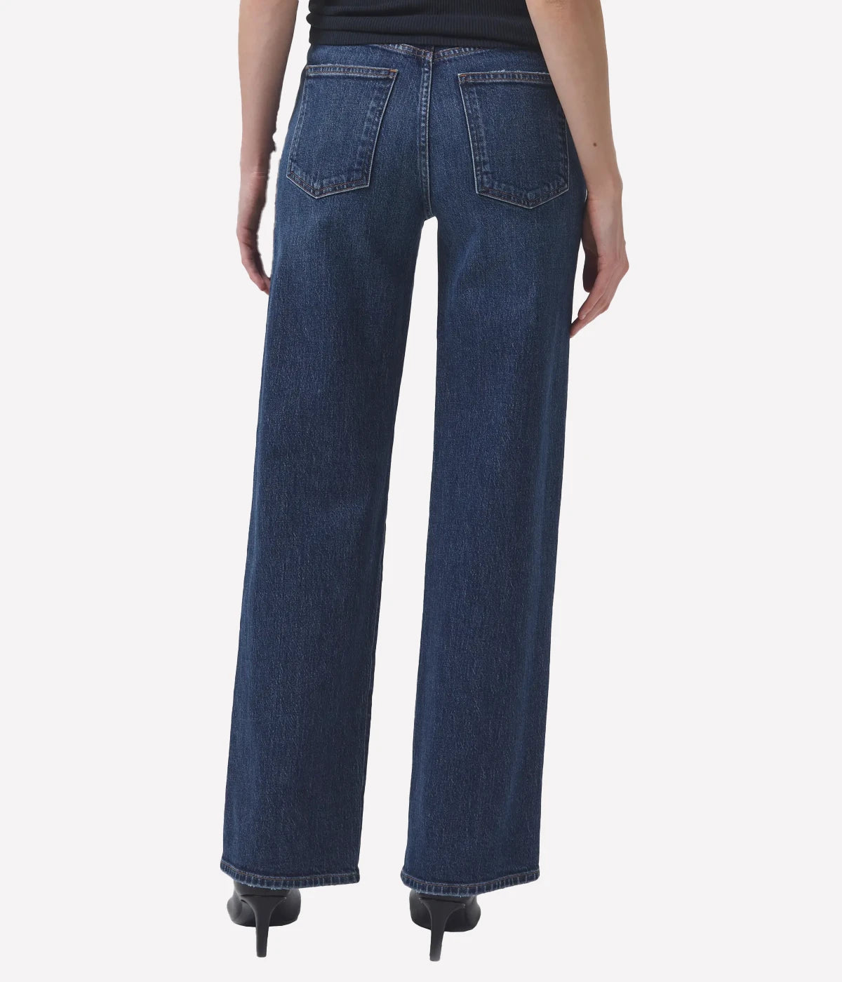 ALT Text: Dark-wash, high-waisted jeans with wide legs, ideal for retro-inspired outfits.