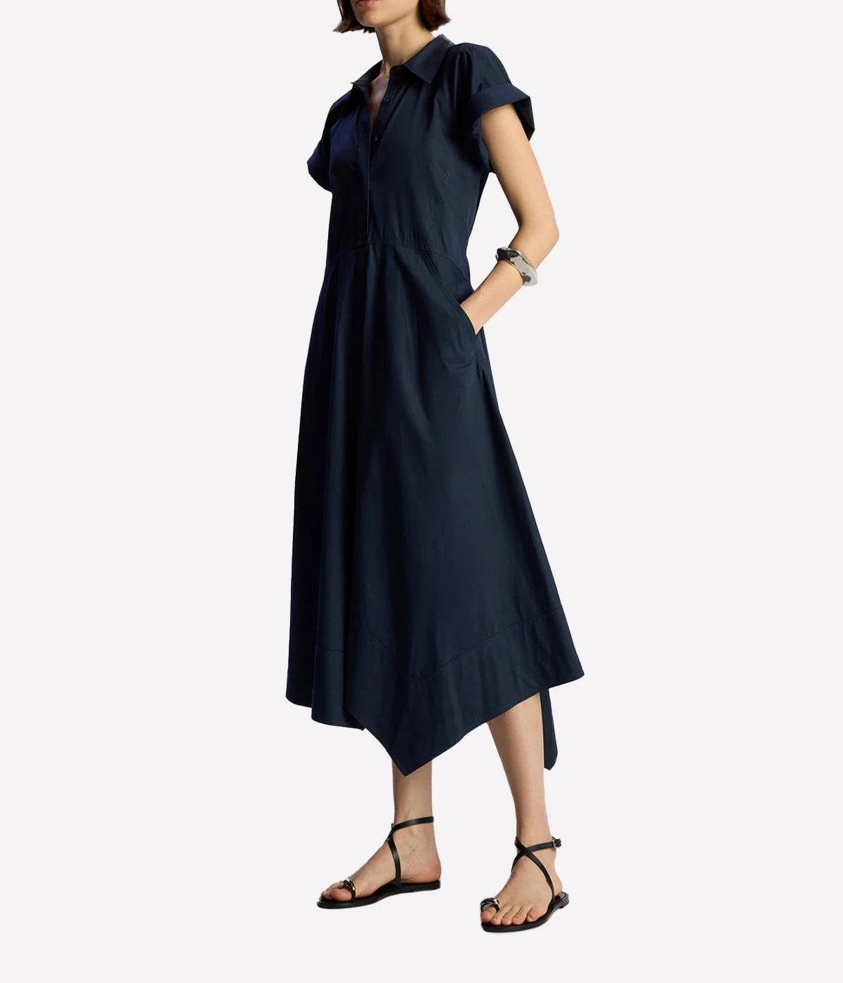 ALT text: Model wears navy cotton twill midi shirtdress with collar, button front and tie waist by A.L.C.