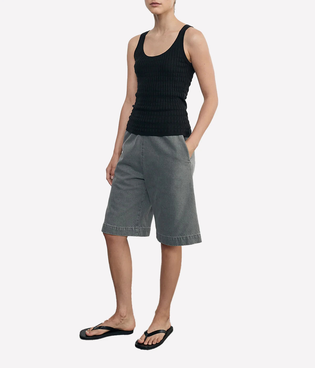 Lightweight sweater-knit tank with a scoop neckline and delicate pointelle stitch, made from a breathable linen-cotton blend.