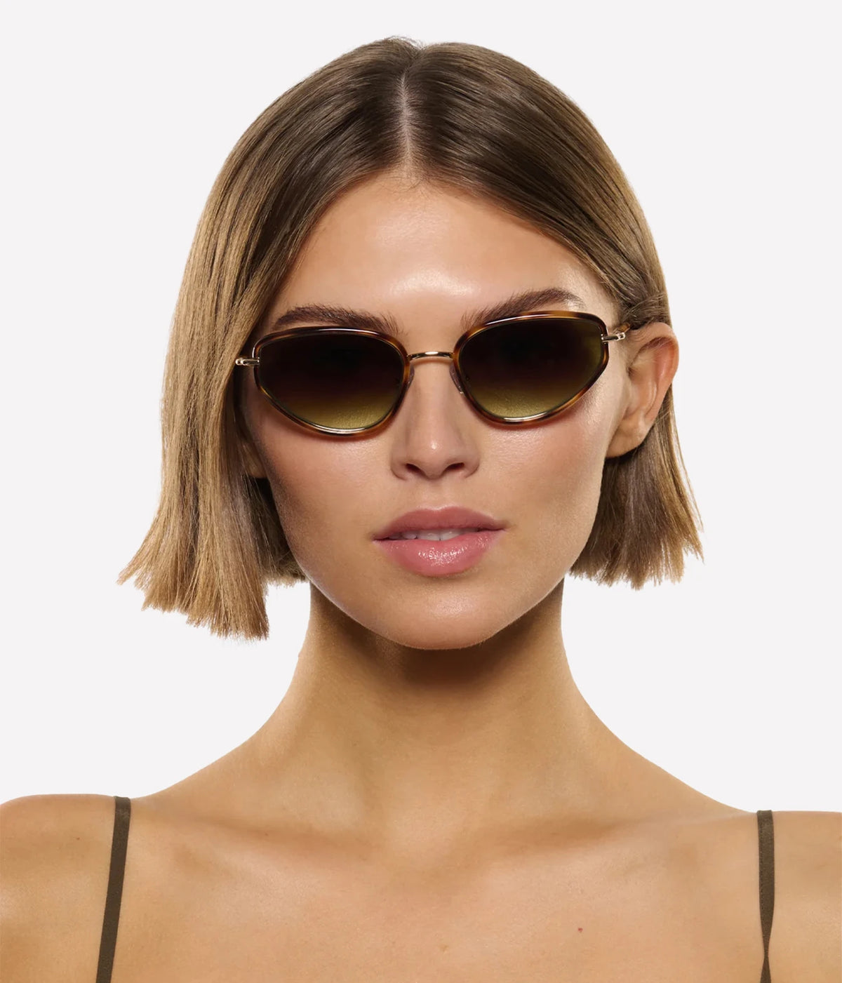 Model with a short bob wearing the KREWE Leah Sunglasses in 18K Maple, front view