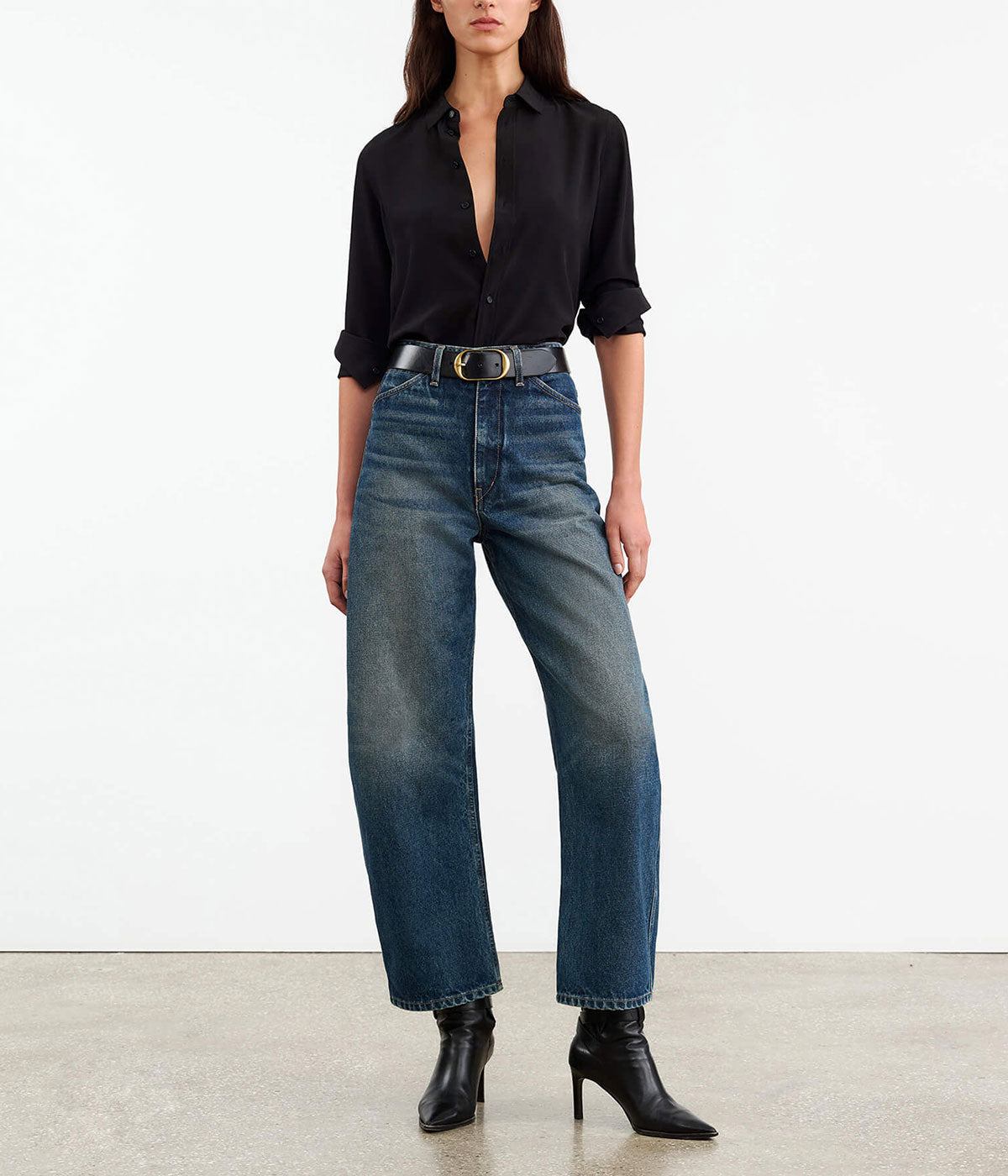 High-rise barrel leg jeans in Japanese non-stretch denim, showcasing a curved silhouette with patch pockets, a zip fly, and shank closure.