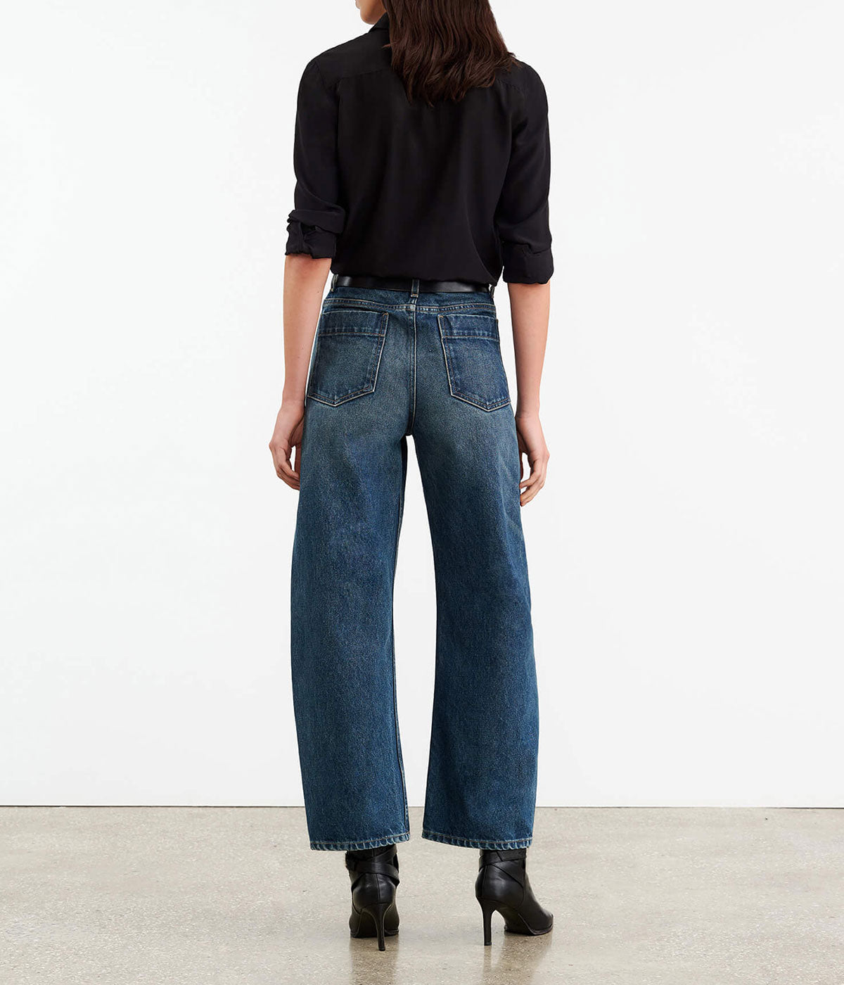 High-rise barrel leg jeans in Japanese non-stretch denim, showcasing a curved silhouette with patch pockets, a zip fly, and shank closure.