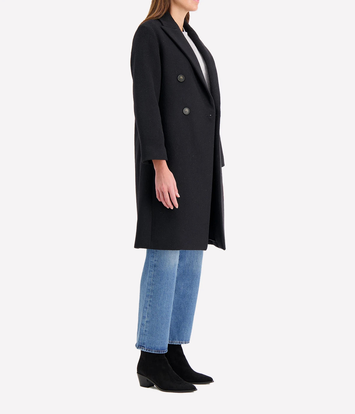 Double-breasted coat with brushed recycled wool blend, featuring peak lapels and side-seam pockets, styled for a sophisticated cold-weather look.