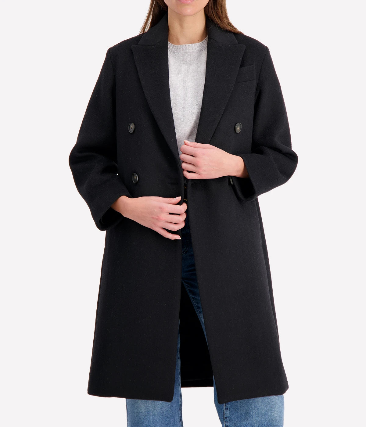 Double-breasted coat with brushed recycled wool blend, featuring peak lapels and side-seam pockets, styled for a sophisticated cold-weather look.