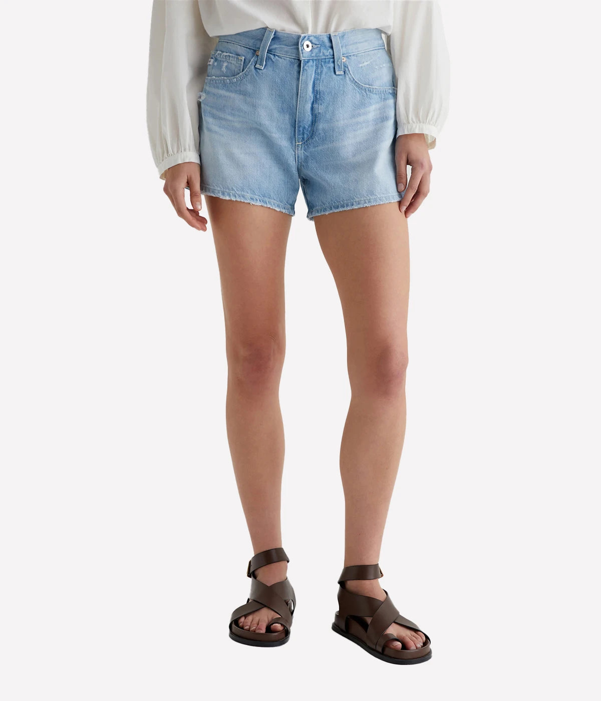 ALT text: AG Hattie Crop jeans in light blue Sioux Rigid Denim with raw hems, side-seam paneling, and distressed front pockets.