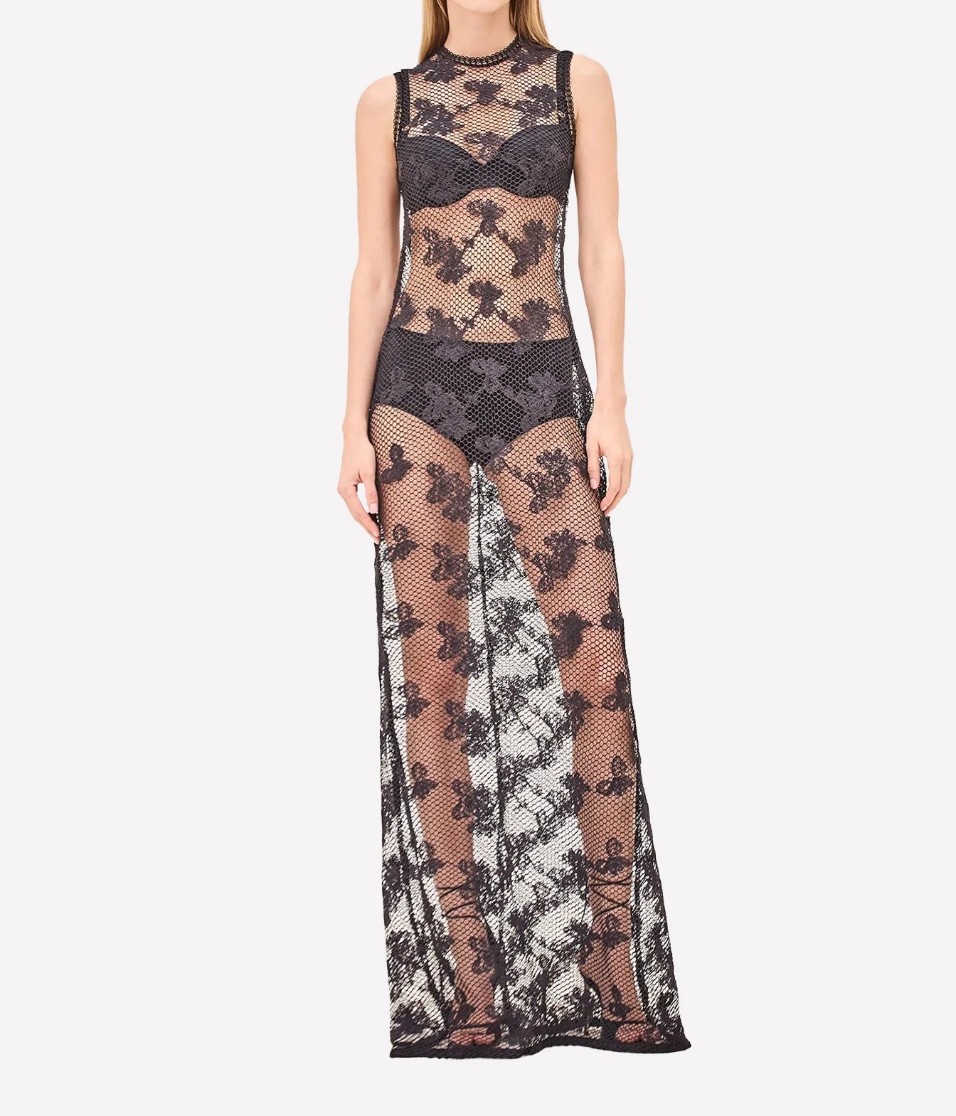 A sleeveless black lace and mesh maxi dress with a sheer floral lace overlay, high neck, and built-in bra, shown on a model against a light gray background.