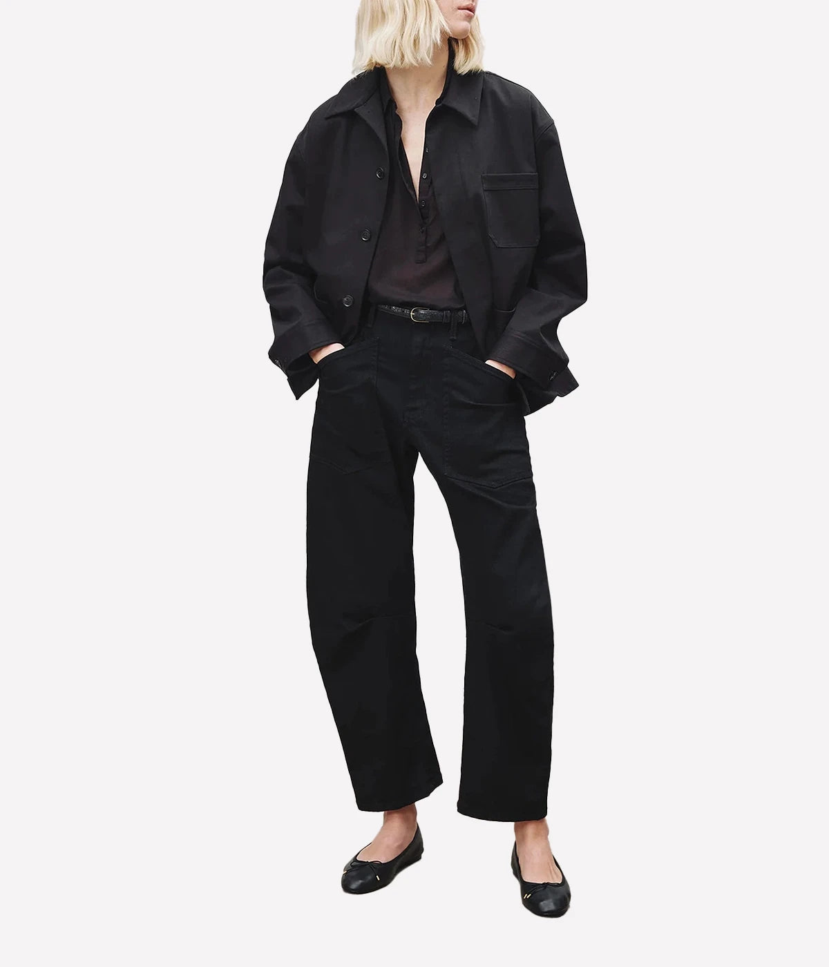 ALT Text: Mid-rise relaxed fit jeans in black with seam detailing and a curved silhouette.