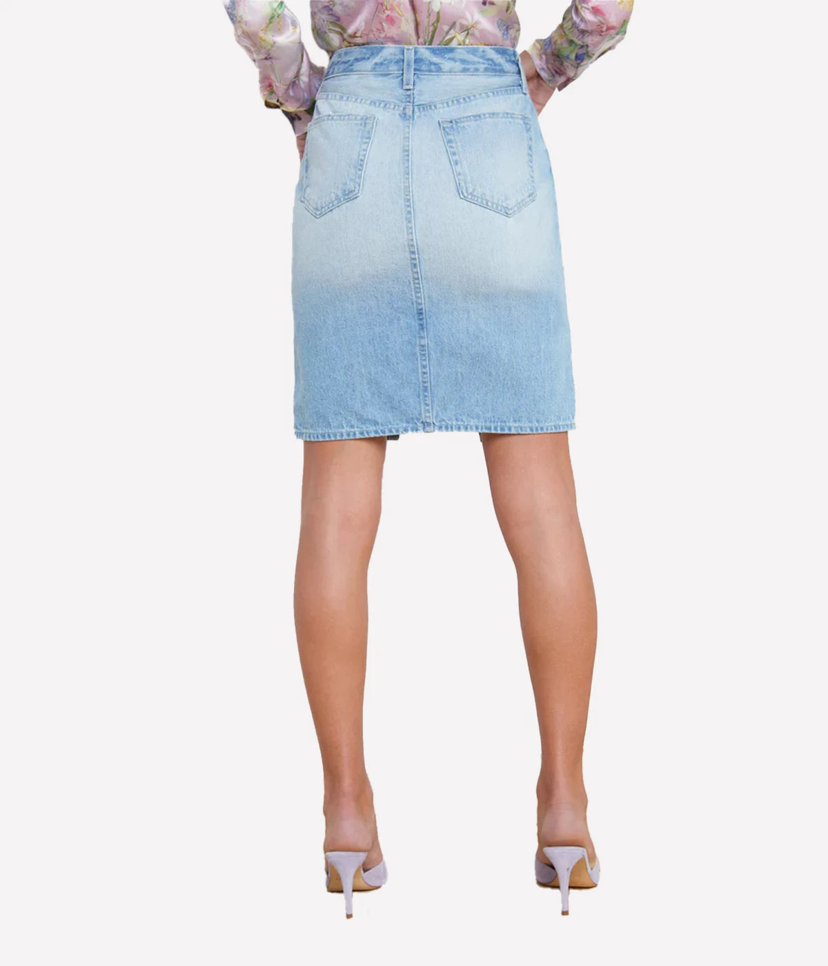 Vintage-inspired denim skirt with a split hem, styled with a linen blouse and sandals for a casual yet refined summer look.