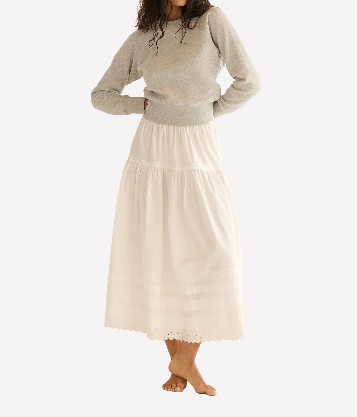 DÔEN Sebastiane Skirt in Powder, styled full body model view highlighting the high-waisted tiered silhouette and scalloped eyelet hem.