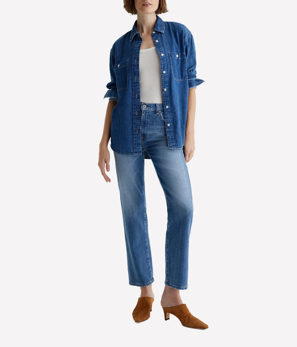 ALT text: Model wears AG Brinley mid-rise straight jeans in faded blue wash with whiskering and vintage-style finish