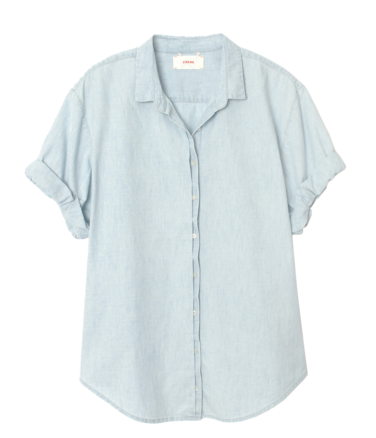 A light blue, slightly oversized shirt with a button-down front, made from soft cotton fabric. The shirt is styled casually, tucked into white trousers with rolled-up sleeves.