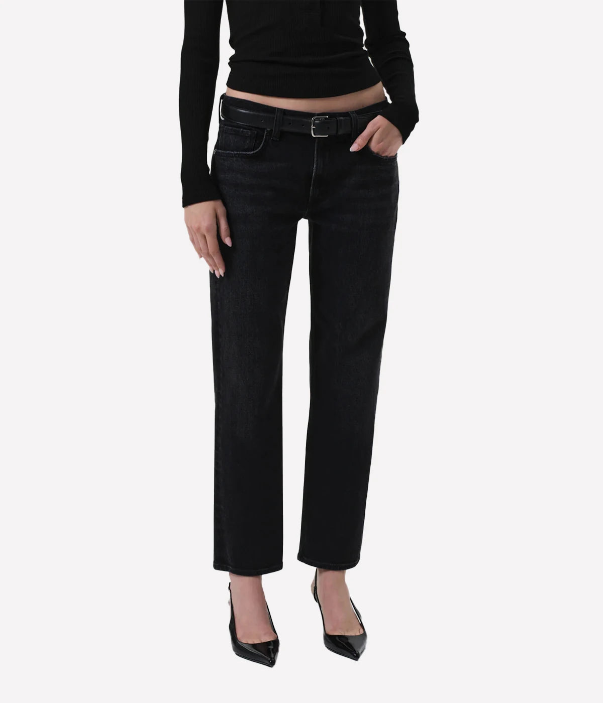 Person wearing black jeans and a black top on a white background