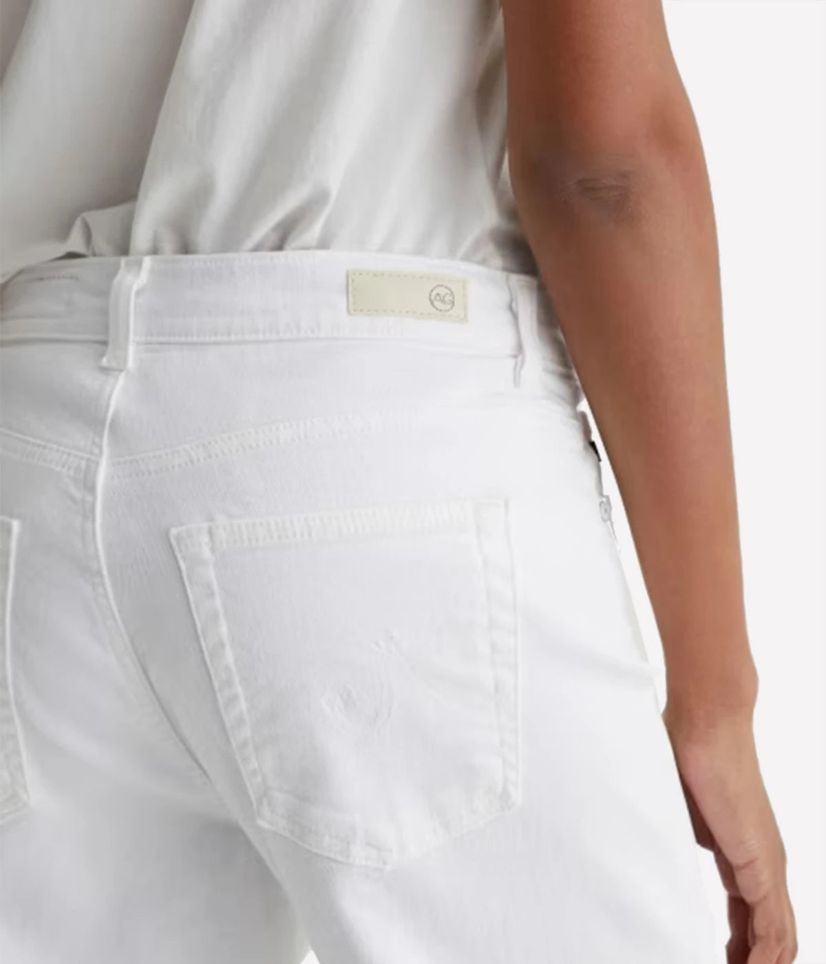 White jeans with a brand logo on a white background