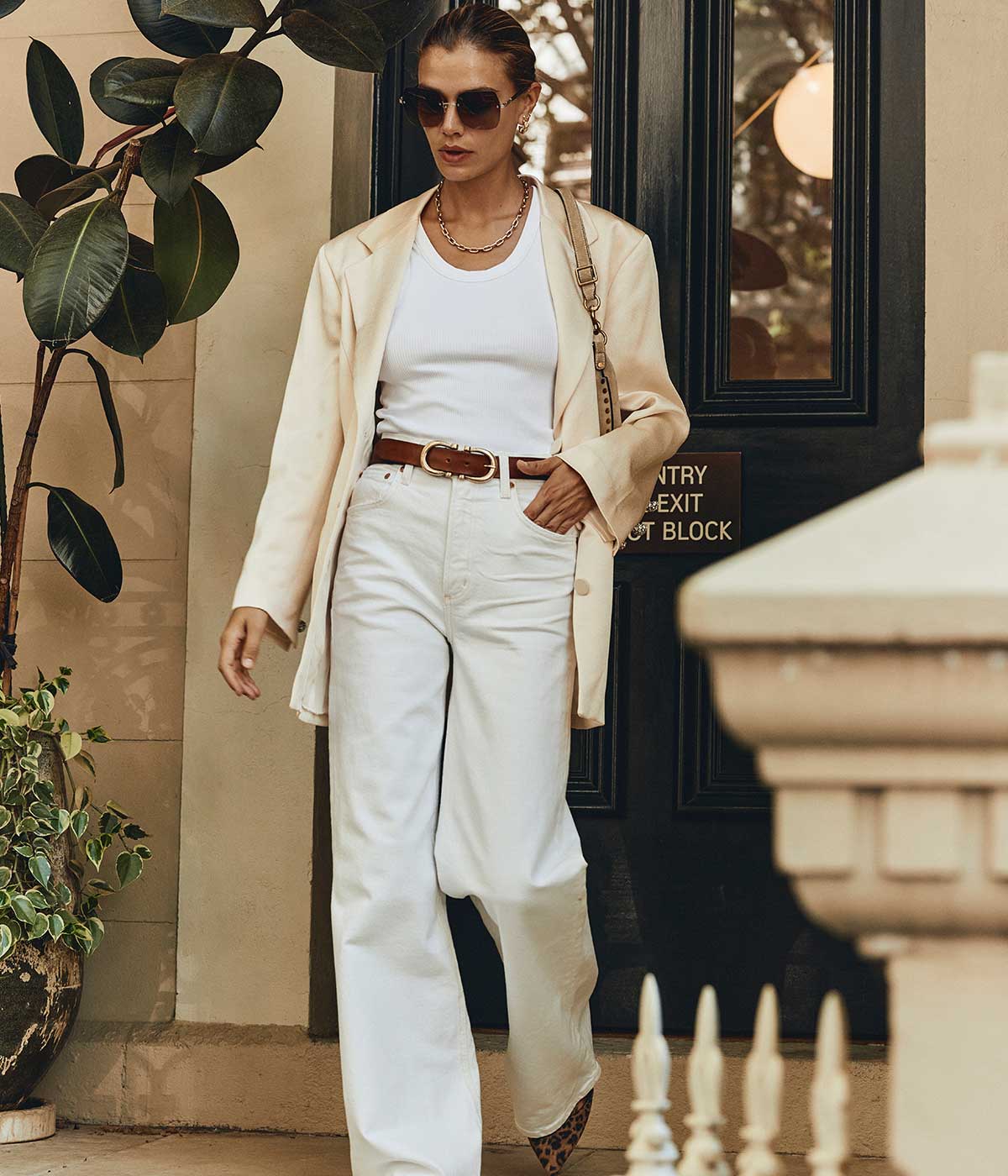 Crafted in ivory satin, it features lightly exaggerated shoulders that create a captivating silhouette, enhanced by crystal button sleeves that shimmer with every movement, commanding attention and radiating confidence and grace. This blazer also includes the brand's signature Smiley pockets and a single-breasted button fastening. Wear it with trousers for a coordinated look or pair it back with jeans for a relaxed style.