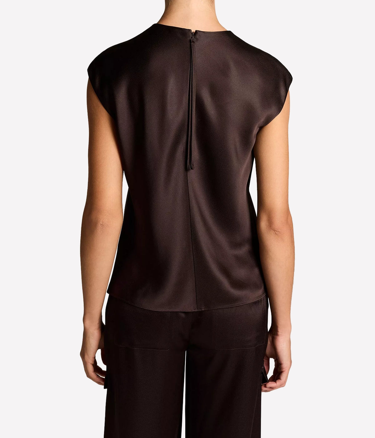Back view of a model wearing the Vince Relaxed Cap Sleeve Top In Cinderwood untucked over matching trousers, showing the relaxed fit
