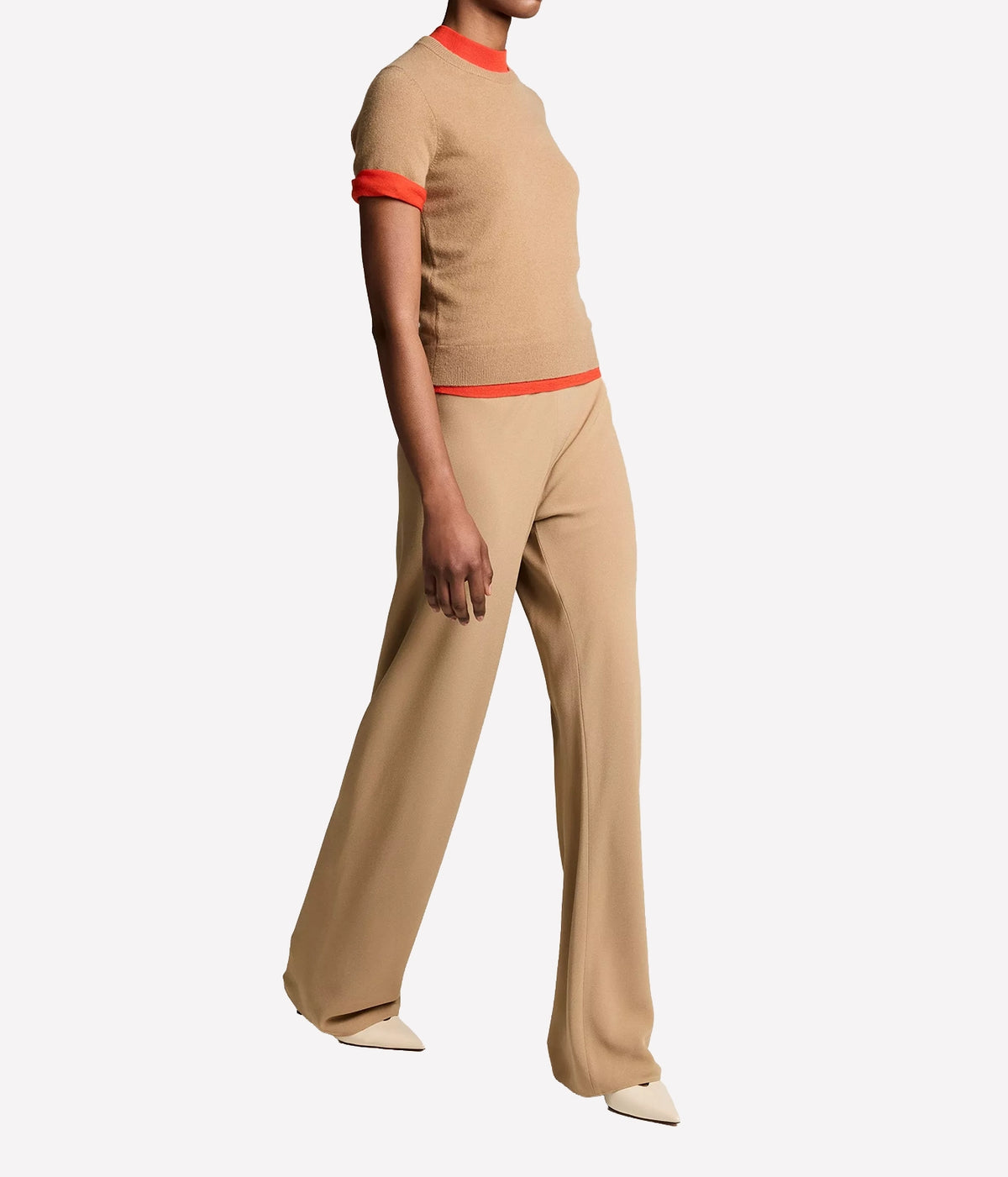 Side view of a model walking in the Vince Colette High Waist Pant In Carmello with the matching red-trimmed top, showing the full-length wide leg