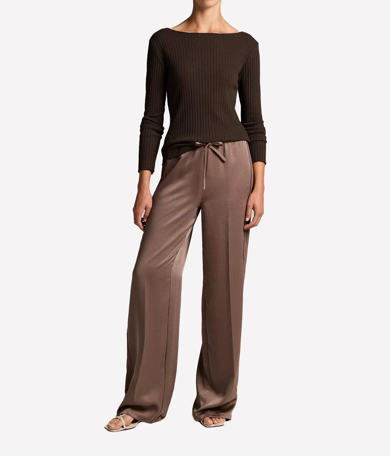 A model wearing a dark brown ribbed long-sleeve boat-neck top
