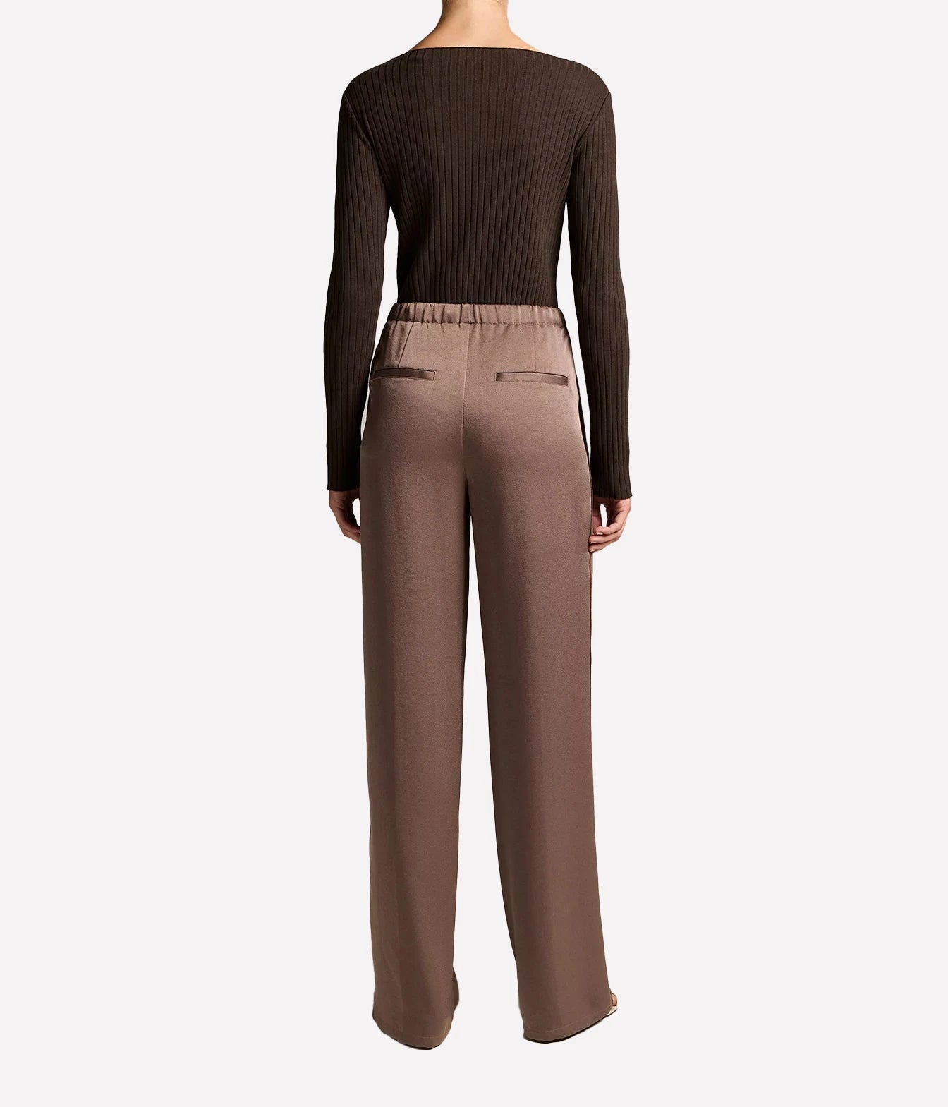 A model shown from the back wearing a dark brown ribbed long-sleeve top