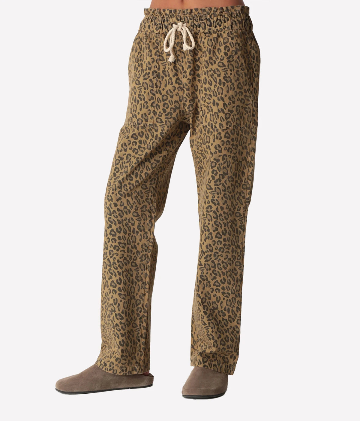 Front view of a model wearing the Electric Rose Easy Leopard Pant in Natural, showing the leopard print, paperbag elastic waist with cream rope drawstring and straight leg, with taupe suede clogs
