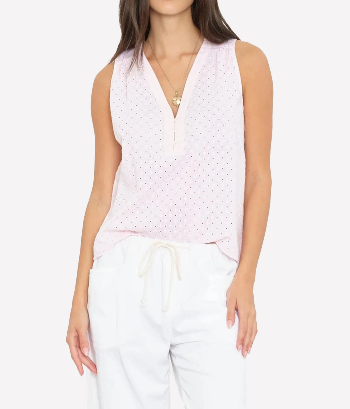 model wearing Xirena Miki Top in Pale rose - sleeveless light pink blouse with v neck and eyelet detailing