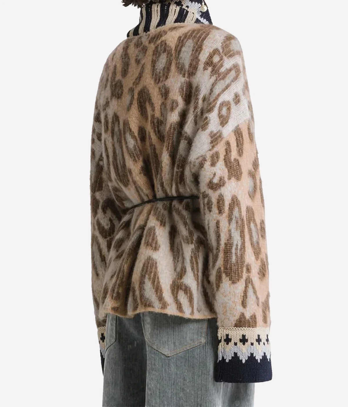 Angled back view of the Forte Forte Brit Leopard alpaca cardigan in Gold, worn with light jeans.