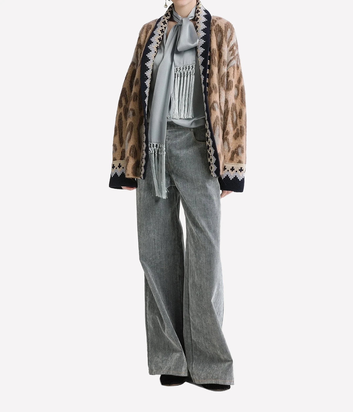 Woman wearing the Forte Forte Brit Leopard alpaca cardigan in Gold with grey wide-leg jeans, full-length front view.