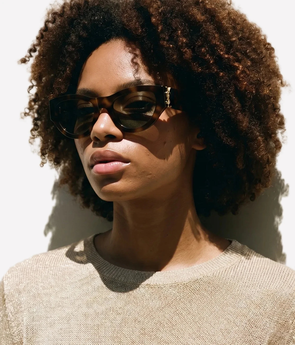 Woman wearing Saint Laurent SL M94/F Cat-Eye Sunglasses in Havana and Green with a neutral knit top, front view
