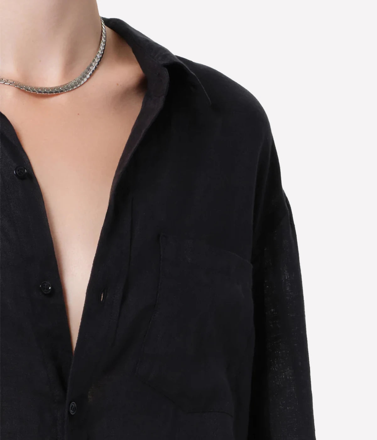 Black shirt with a deep neckline on a plain background