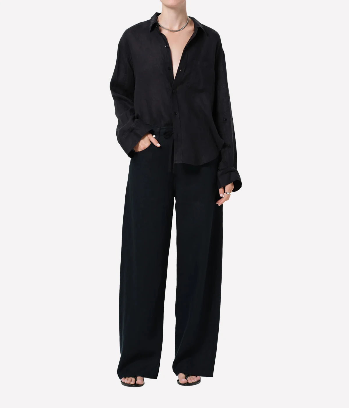 Person wearing a black outfit on a white background