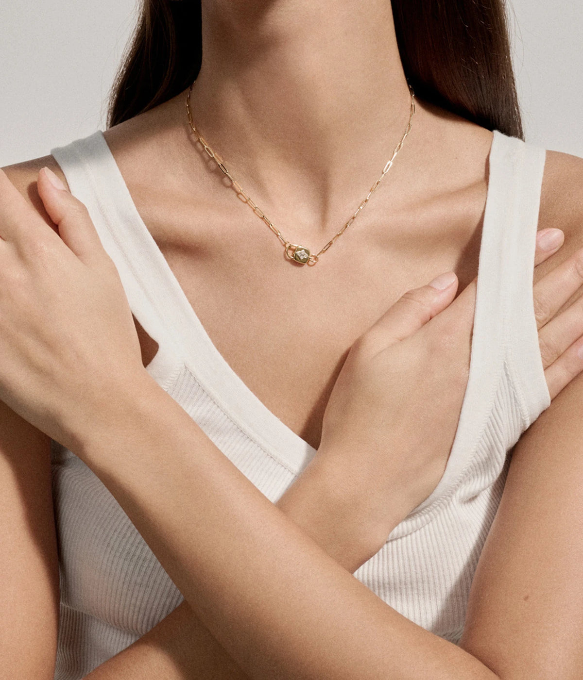 Model with arms crossed over the chest wearing the Pascale Monvoisin Louise Necklace with a white tank top
