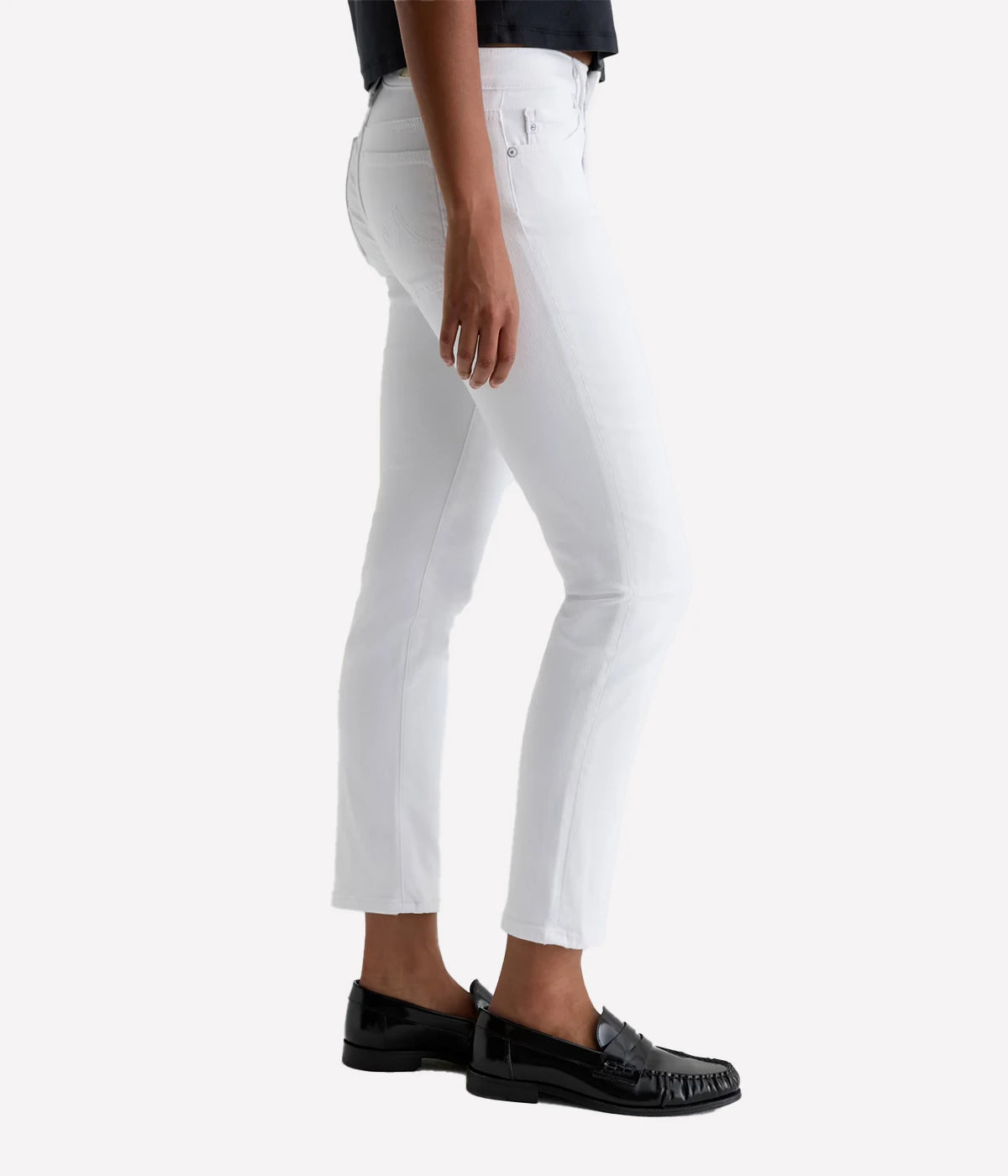 White pants worn by a person on a white background