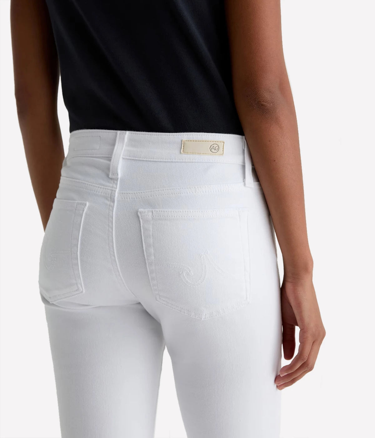 White jeans worn by a person on a white background