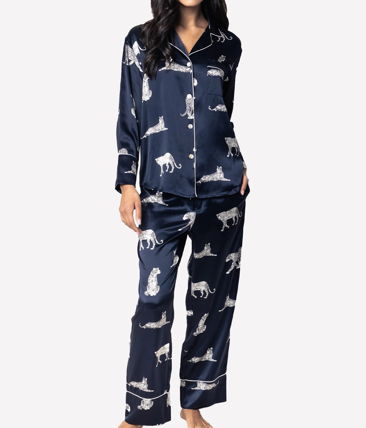 Front view of a model wearing the Petite Plume Mulberry Silk Long Pyjama Set in Panthère de Nuit with the shirt fully buttoned and the straight leg pants at full length