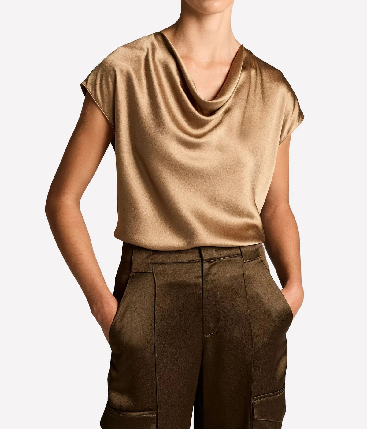 Woman wearing a Carmello cowl neck blouse with brown trousers