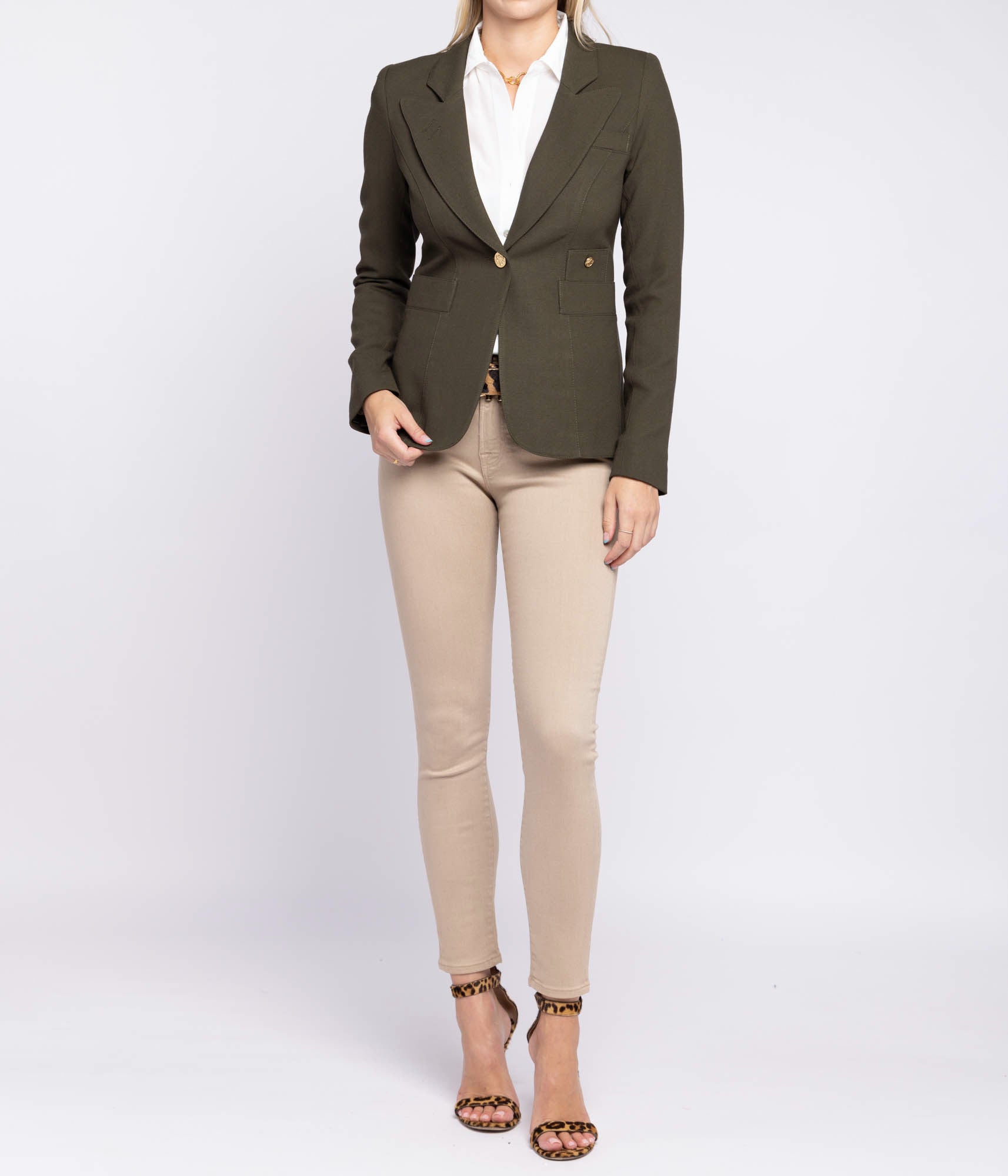 ALT text for images: Tailored blazer with brass hardware, cut-out back detail, and single-breasted design, styled with tailored trousers and a slip dress.