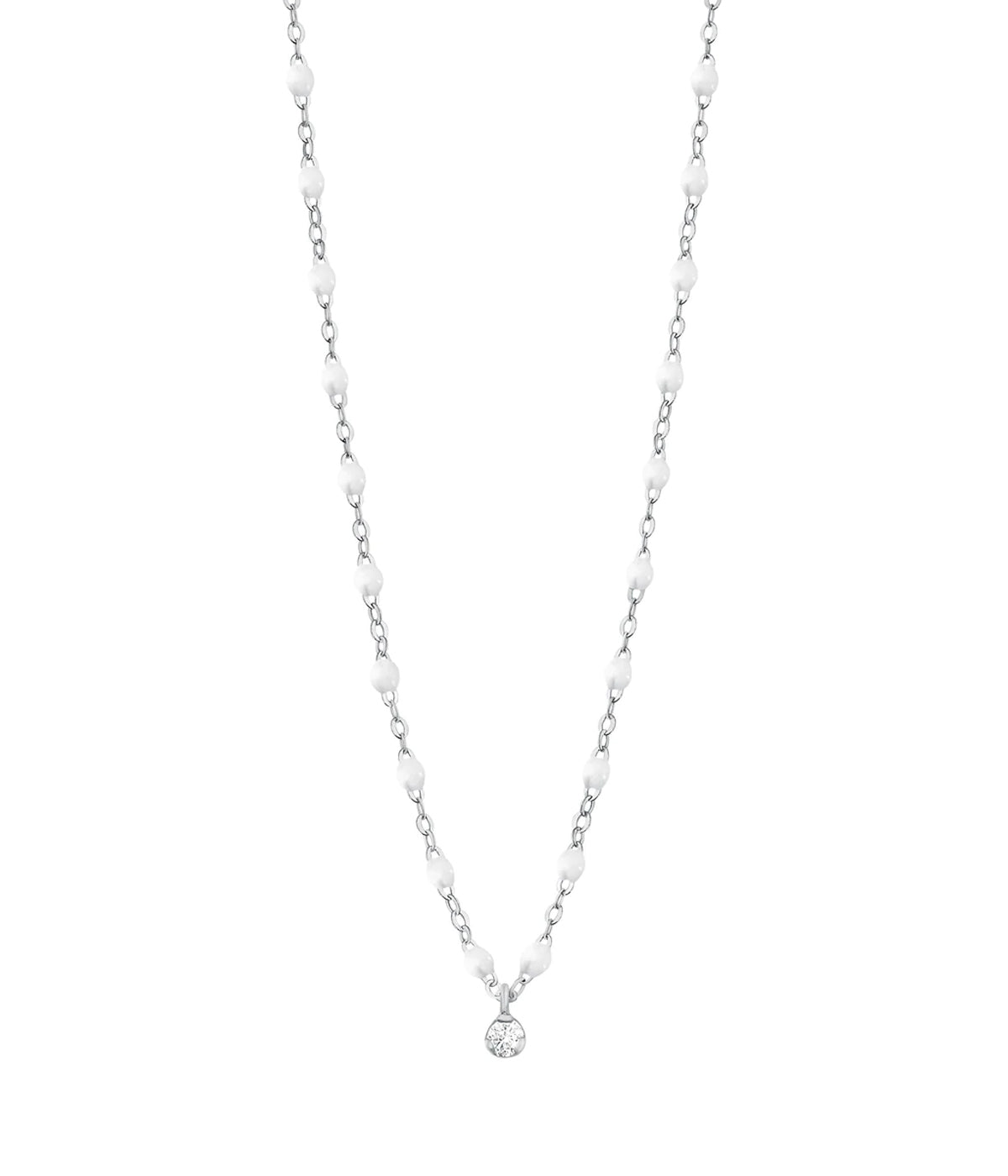 An 18K white gold necklace centered by a round-cut glittering diamond pendant. Hand made dainty chain interspersed with white resin beads. An elegant jewellery item, perfect for pairing or layering. 