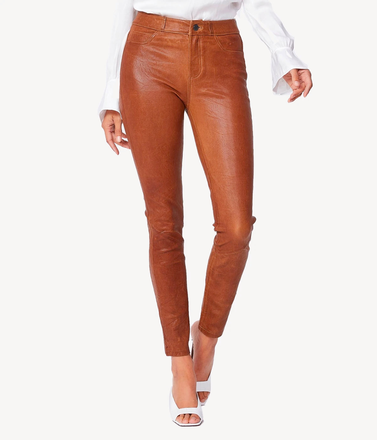 High-rise leather skinny pants in deep brown, crafted from 100% lamb leather bonded with stretch-cotton, featuring a subtly wrinkled texture.