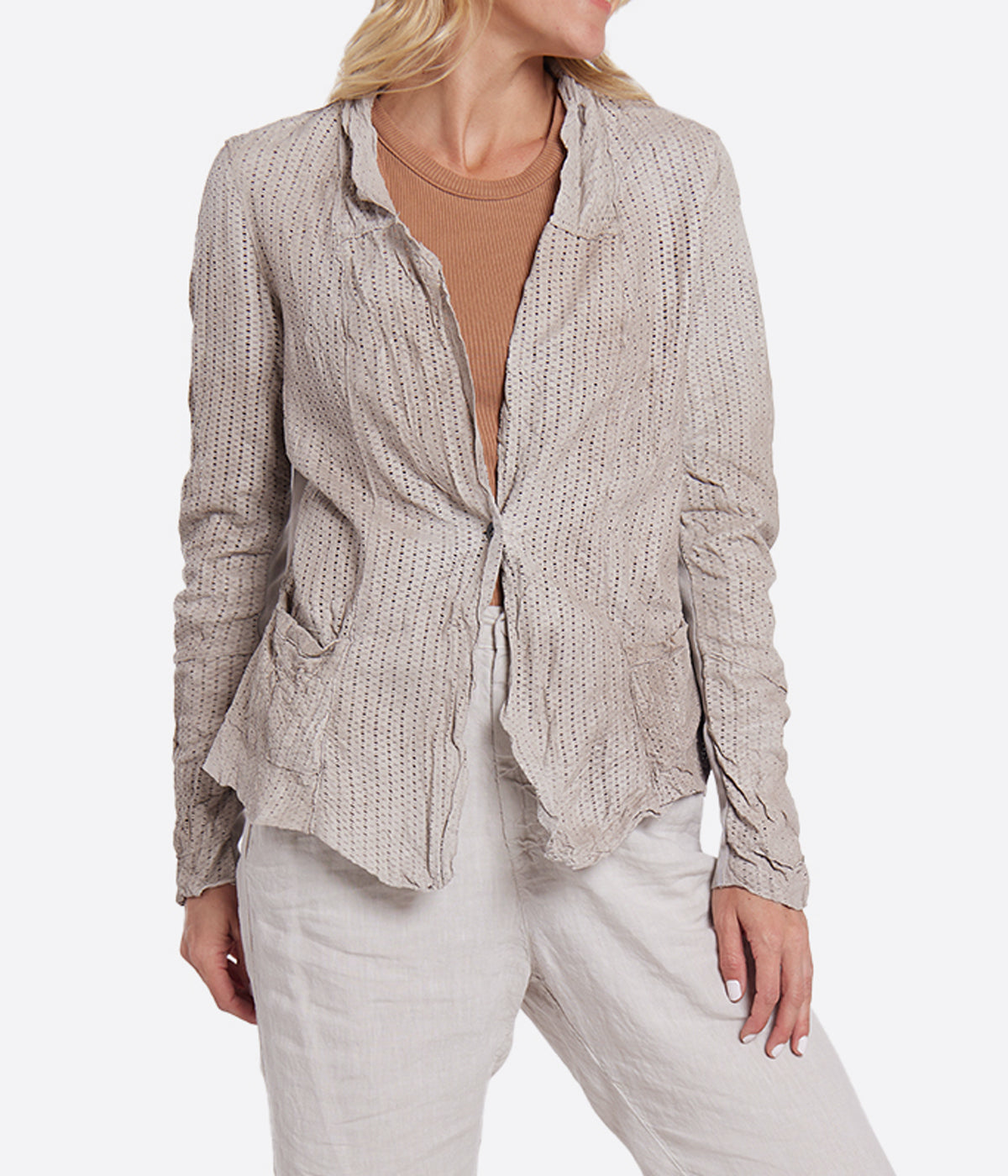 Image of a light weight textural leather beige jacket featuring two front pocket details and a button for closure. 