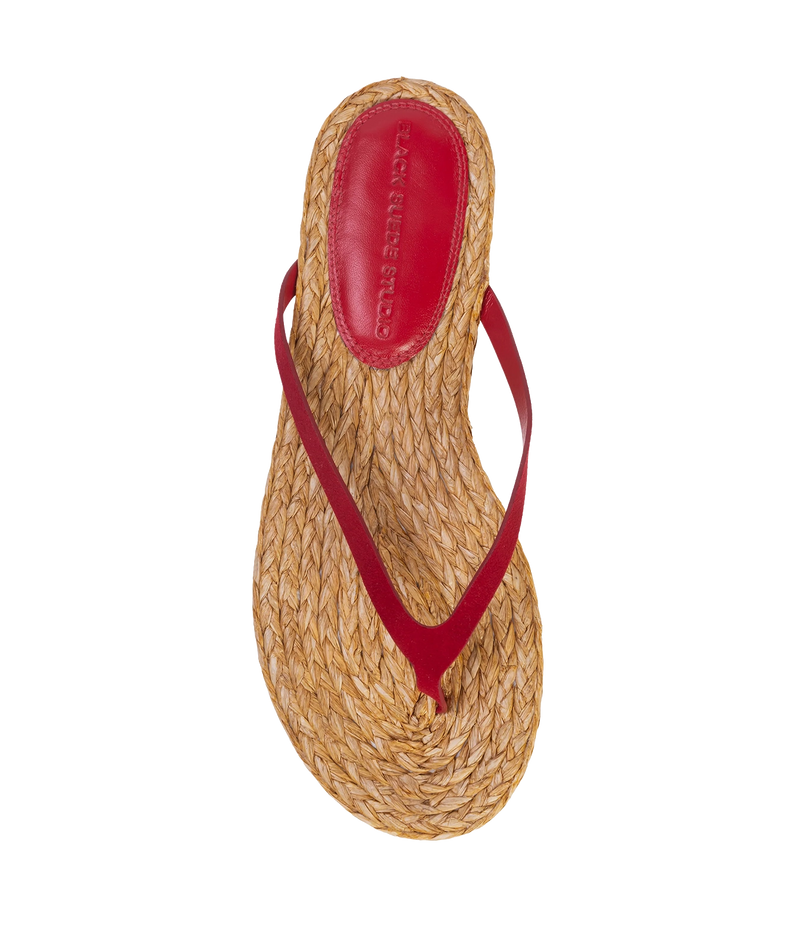 A single woven straw thong sandal with a red leather strap and red and raffia insole - Alaya Sandal in Cherry Suede