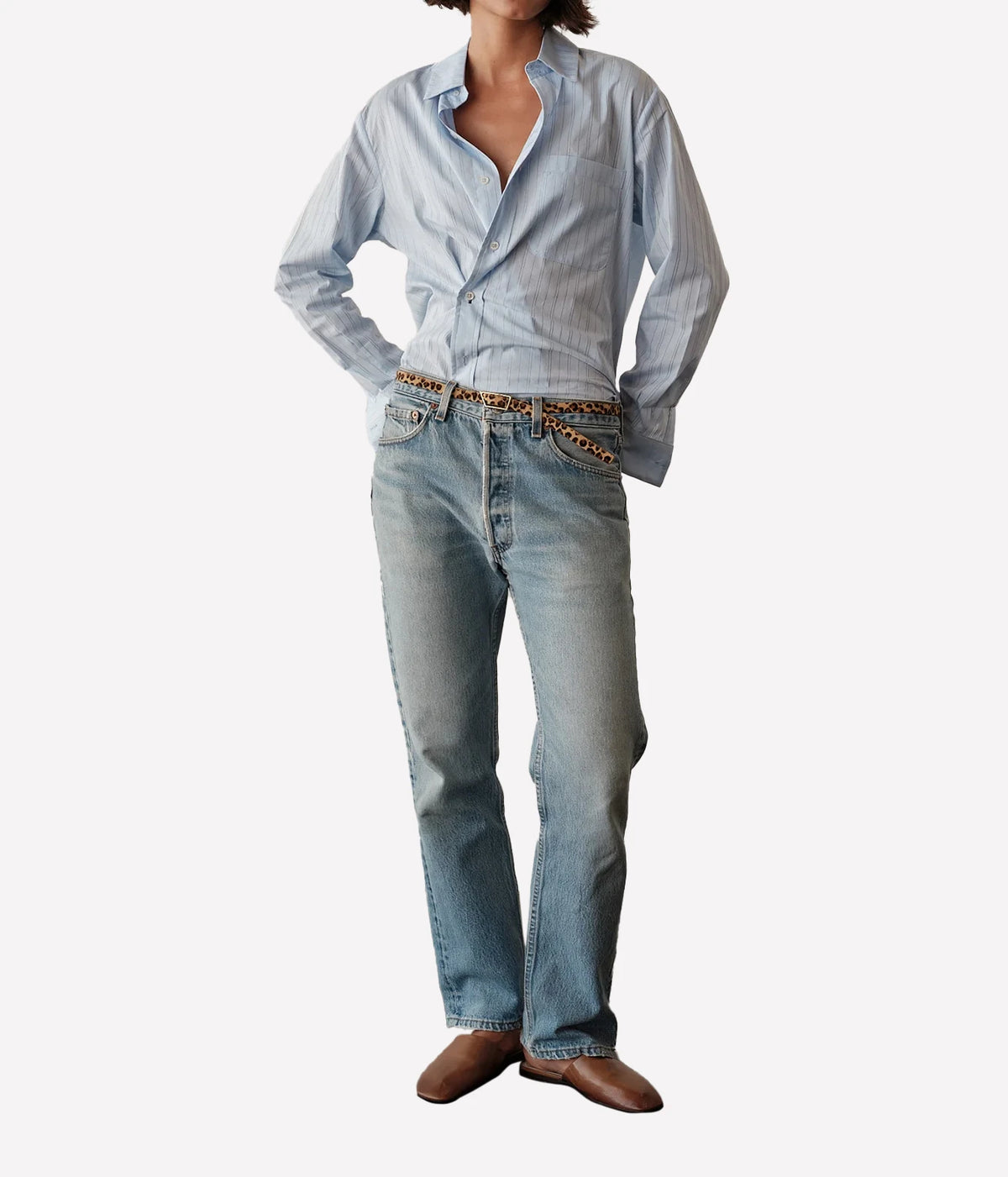 Full-length front view of a model wearing the CISSA Daily Shirt in Blue Needle with light-wash straight-leg jeans and brown loafers, showing the relaxed fit