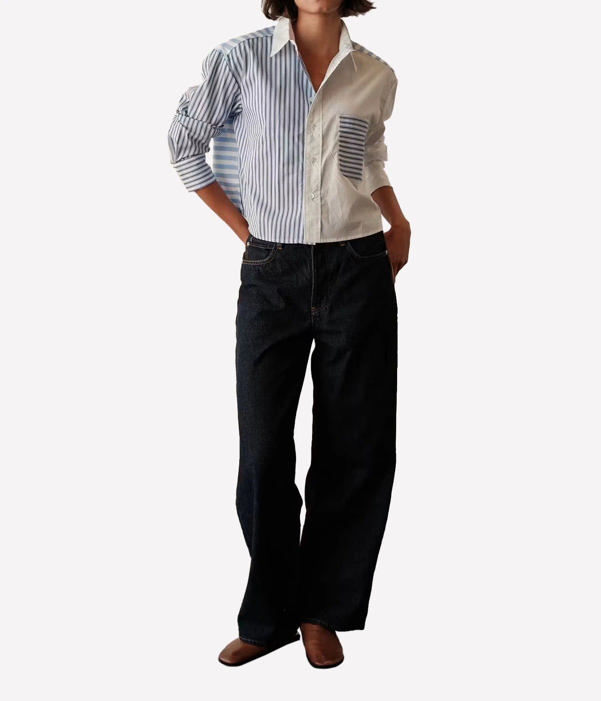 Full-length front view of a model wearing the CISSA Shorty Shirt in Stripe Scrappy untucked with dark wide-leg jeans and brown flats